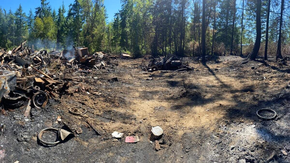 This image shows the aftermath of a property fire in Pierce County. The remains of Leeland “Butch” Smith’s home are on the left.