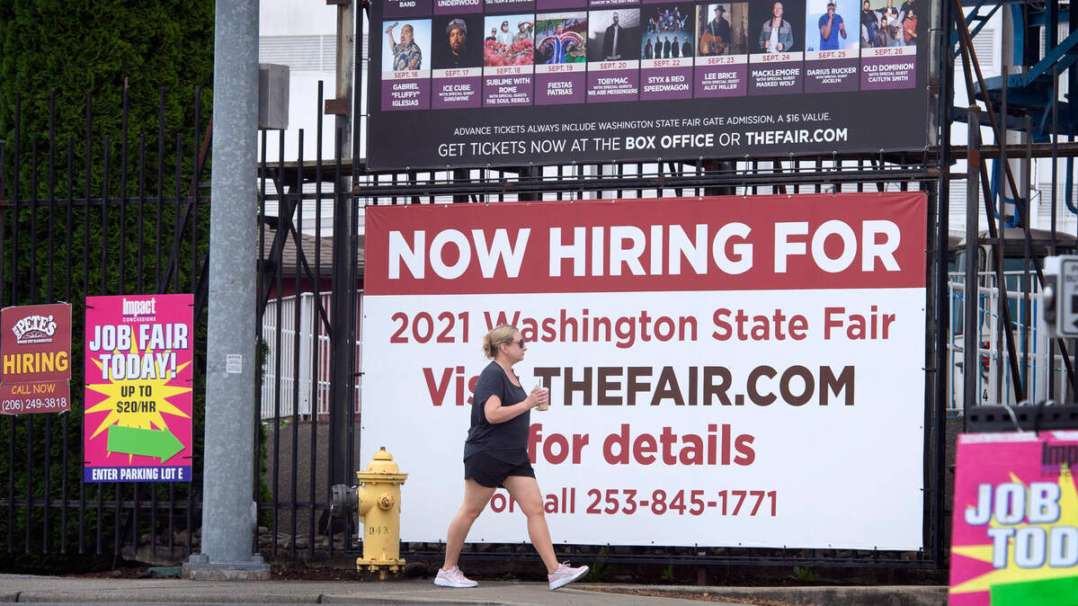 Posters call out to job seekers to fill positions for the Washington State Fair, shown in Puyallup, Washington, on Tuesday, Aug. 17, 2021.