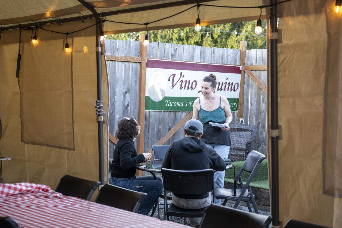 Anna Brodersen, a manager at Tacoma Pie, greets guests sitting on the patio on Friday, April 10. With a tent and a bocce court, it’s an outdoor restaurant hideaway that has flown under the radar.