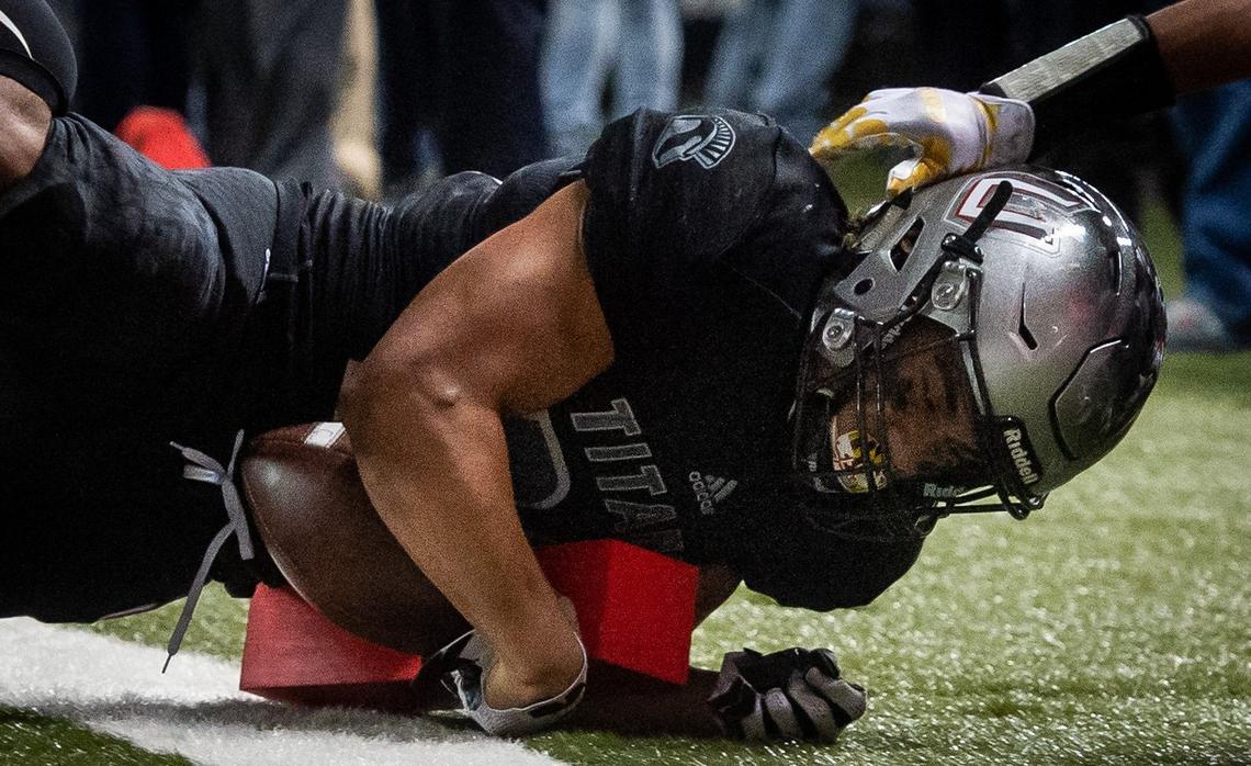Union’s Joseph Siofele (26) hits the pylon as he dives for a touchdown in the fourth quarter. Union played Lake Stevens in the WIAA 4A football state championship game at the Tacoma Dome in Tacoma, Wash., on Saturday, Dec. 1, 2018.