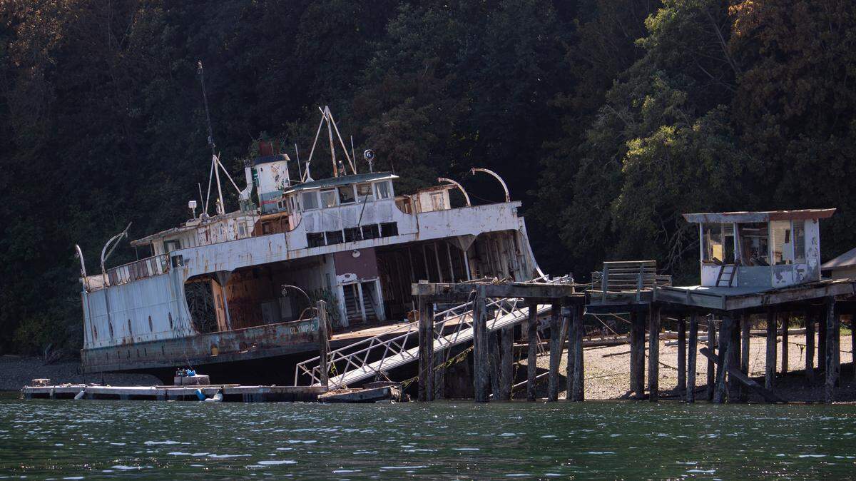 The Olympic, a retired Washington state ferry, is abandoned off Ketron Island in the Puget Sound. State officials cannot remove the vessel due to its large size and location on private property. For 15 years, it hasn’t moved.