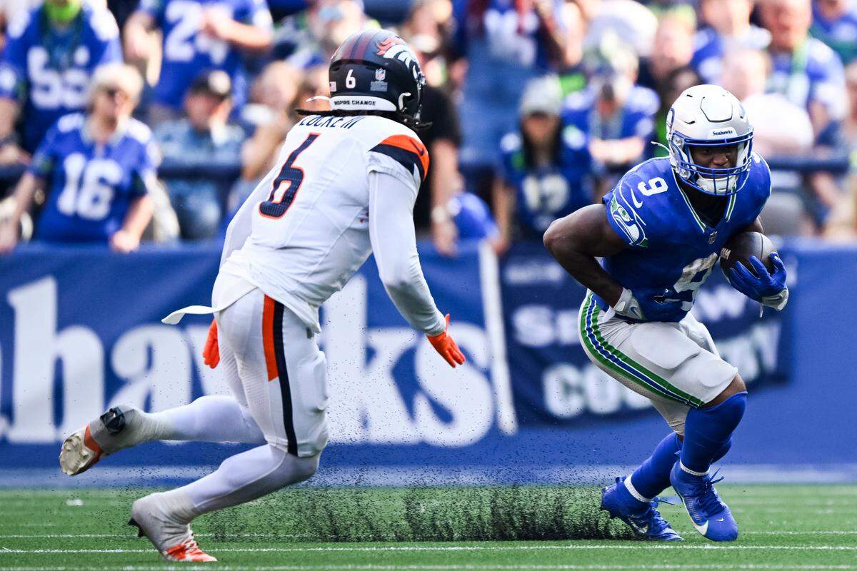 Seattle Seahawks running back Kenneth Walker III (9) gets to the edge around Denver Broncos safety P.J. Locke (6) during the fourth quarter of the game at Lumen Field, on Sunday, Sept. 8, 2024, in Seattle, Wash.