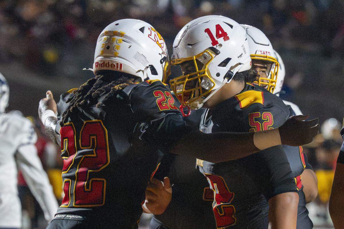 Mount Tahoma’s Keshawn Hines (22) is celebrated by Mount Tahoma’s Andrew Savaiinaea (52) in the end zone during a game against Bellarmine on Friday, Oct. 10, 2025, at Mount Tahoma in Tacoma, Wash.