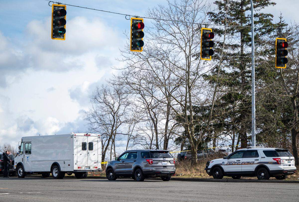 Police investigate the scene where a 26-year-old man was shot and killed inside a tent at a Tacoma homeless encampment near the corner of South 74th Street and Tacoma Mall Blvd in Tacoma, Wash. on Feb. 28, 2023.