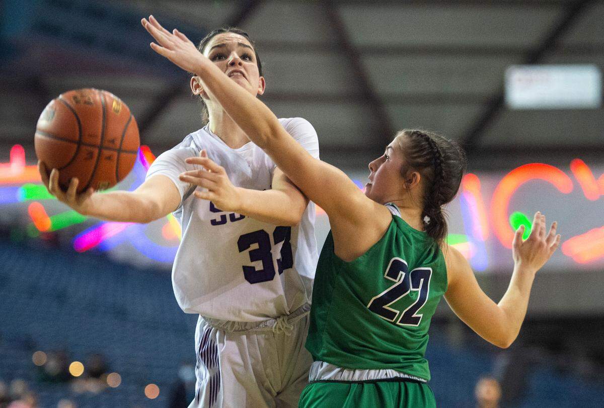 Sumner’s forward Alyson Deaver (33) goes in for a layup as Woodinville’s Autumn Sellie (22) defends during the 4A state championship game at Tacoma Dome in Tacoma, Wash. on Saturday, March 5, 2022.