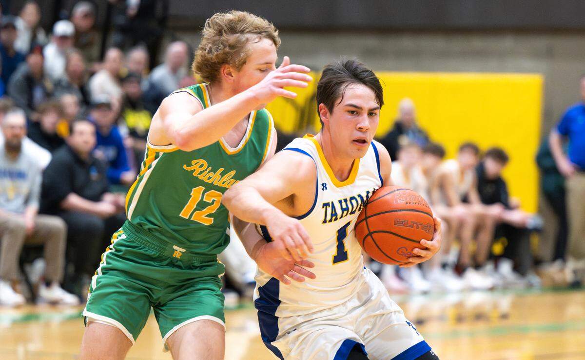 Tahoma’s Carter Stonerock (1) cuts to the basket against Richland’s Joshua Woodard (12) during the 4A state regional boys game at Auburn Senior High School, on Saturday, Feb. 24, 2024 in Auburn, Washington.