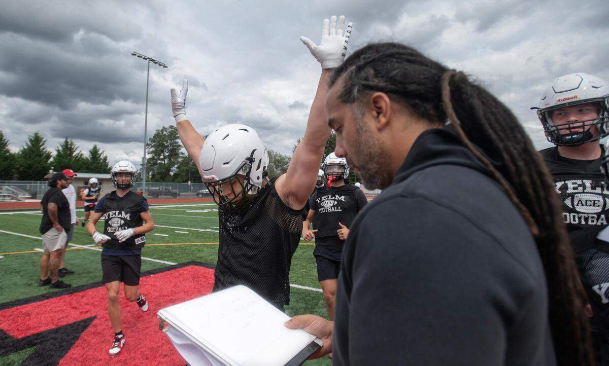 Yelm running back Nathan Ford huddles teammates during the opening day of football practice at Yelm High School in Yelm, Washington, on Wednesday, Aug. 21, 2024.
