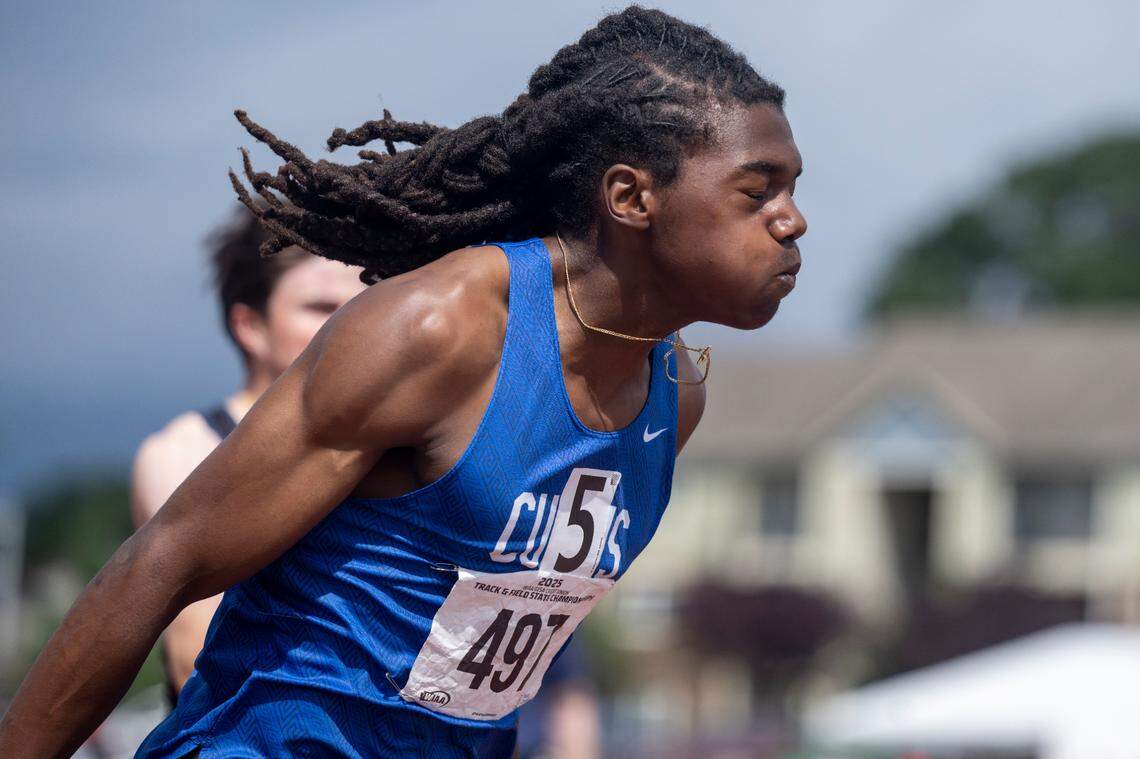 Curtis’ Nicholas Altheimer, left, sprints into first place in the 4A boys 200-meter dash final on Saturday, May 31, 2025, during the 2025 WIAA Track & Field Championships at Mount Tahoma High School in Tacoma, Wash. Altheimer’s 21.07-second run set a new state meet record.