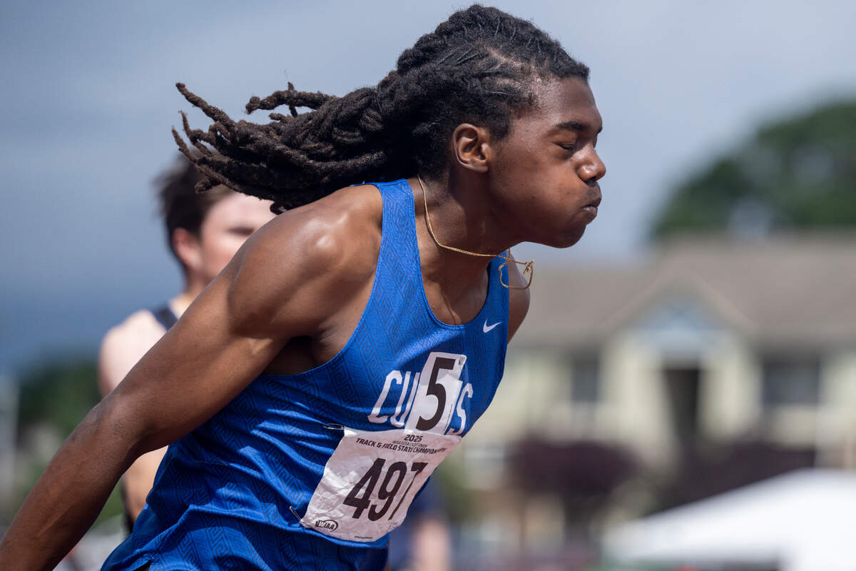 Curtis’ Nicholas Altheimer, left, sprints into first place in the 4A boys 200-meter dash final on Saturday, May 31, 2025, during the 2025 WIAA Track & Field Championships at Mount Tahoma High School in Tacoma, Wash. Altheimer’s 21.07-second run set a new state meet record.