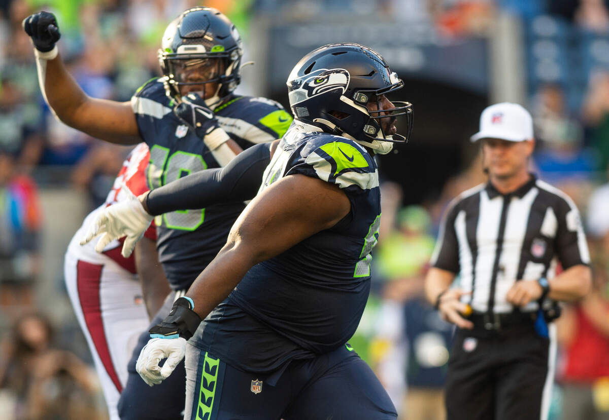 Seattle Seahawks defensive end Shelby Harris (93) celebrates after tackling Arizona Cardinals quarterback Kyler Murray (1) in the fourth quarter of an NFL game on Sunday, Oct. 16, 2022, at Lumen Field in Seattle.