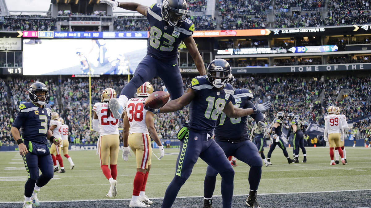 Seattle Seahawks wide receiver Jaron Brown, (18) celebrates with wide receiver David Moore (83) after Brown caught a pass for a touchdown during the second half of an NFL football game against the San Francisco 49ers, Sunday, Dec. 2, 2018, in Seattle. (AP Photo/John Froschauer)
