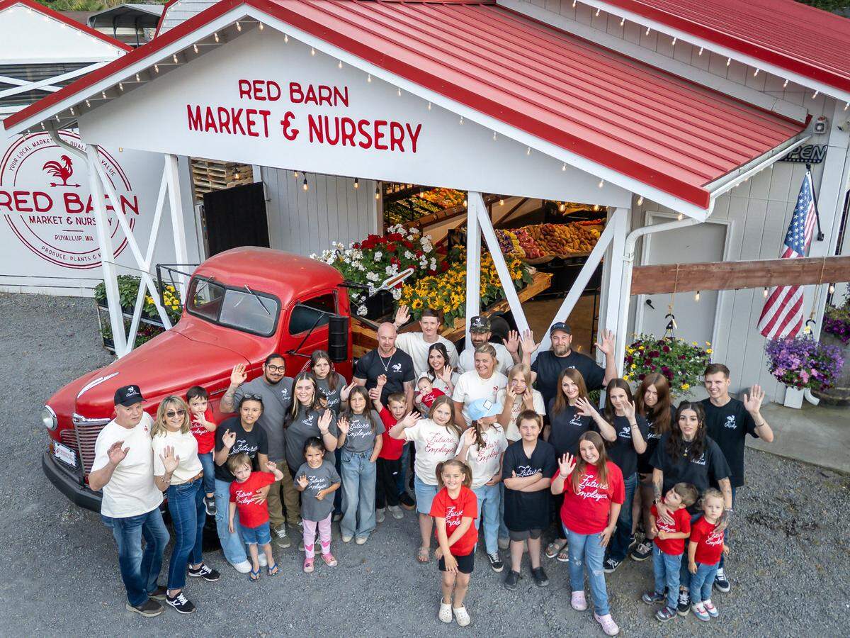 Kimberly Charlton, the woman on the far left, poses with her family outside of Red Barn Market & Nursery on June 14, 2025. Charlton is the new owner of the beloved business, which started in 2018.