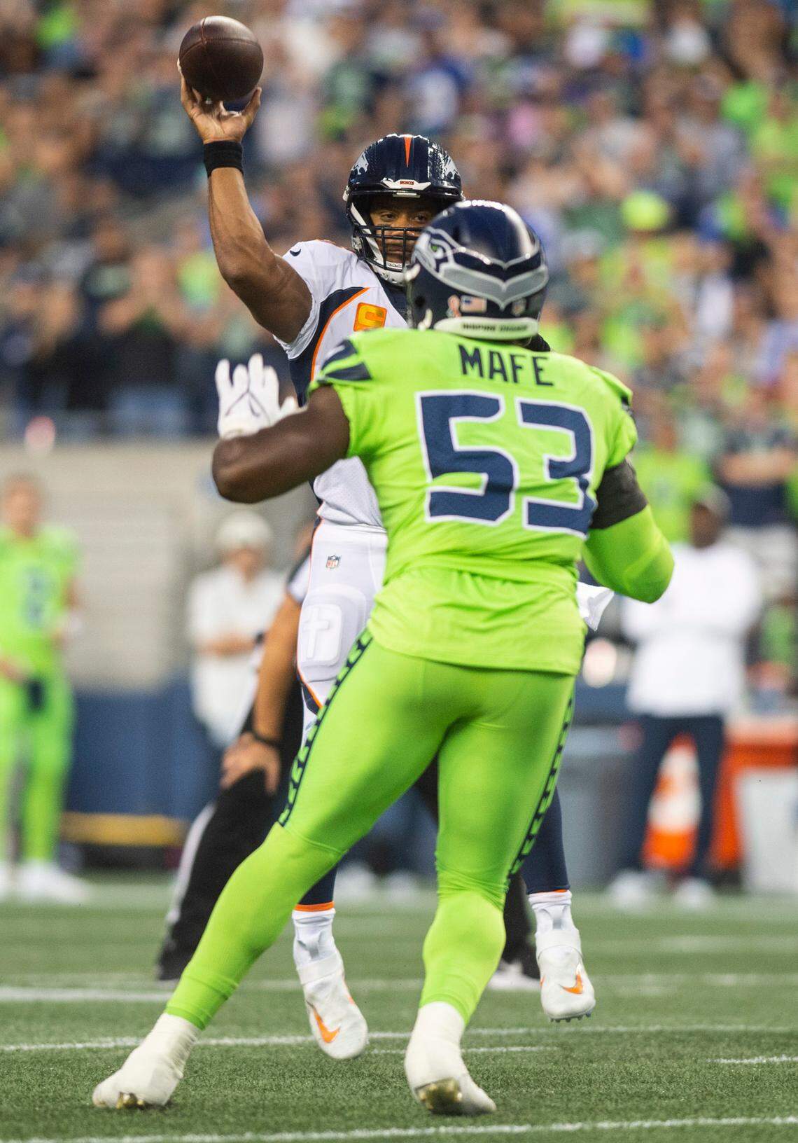 Denver Broncos quarterback Russell Wilson (3) passes over Seattle Seahawks linebacker Boye Mafe (53) in the fourth quarter of an NFL game on Monday, Sept. 12, 2022, at Lumen Field in Seattle.