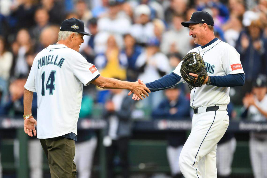 Oct 4, 2025; Seattle, Washington, USA; Former Seattle Mariner manager Lou Piniella shakes hand with head coach Dan Wilson before game one of the ALDS round against the Detroit Tigers for the 2025 MLB playoffs at T-Mobile Park in Seattle on Saturday, Oct. 4, 2025.