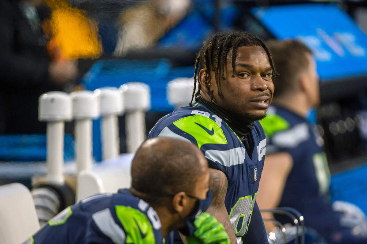 Seattle Seahawks tight end Gerald Everett (81) looks over at wide receiver Tyler Lockett (16) on the bench as the Arizona Cardinals close out the game in the fourth quarter of an NFL game on Sunday afternoon at Lumen Field in Seattle.