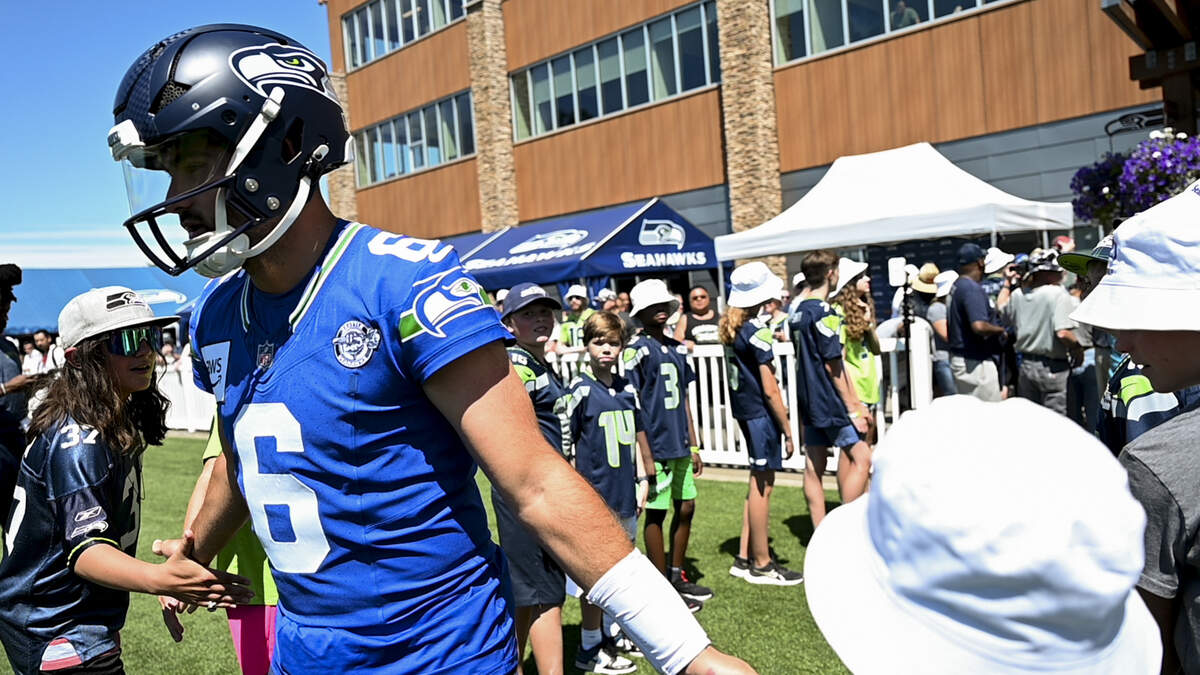 Seahawks quarterback Sam Howell (6) greets fans during the first day of training camp at the Virginia Mason Athletic Center, on Wednesday, July 24, 2024, in Renton.