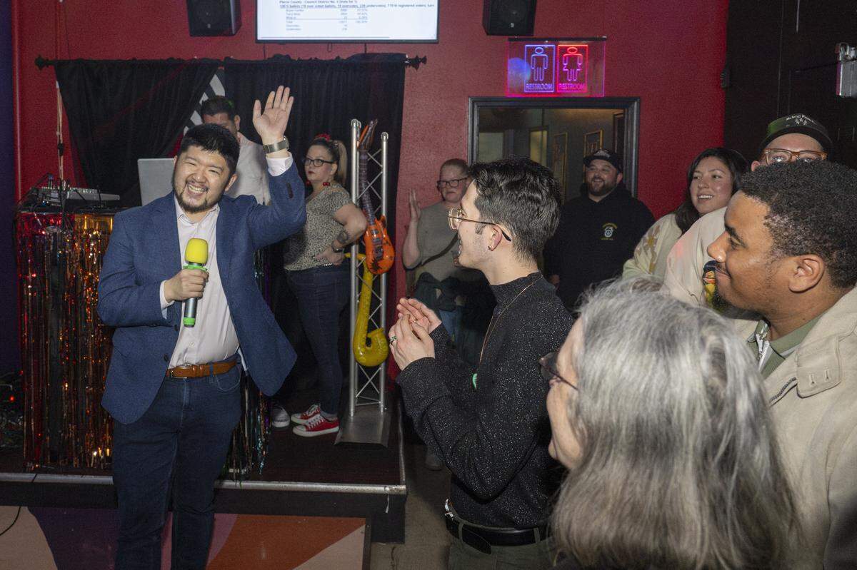 Pierce County Council incumbent Bryan Yambe, left, gives a speech to supporters after garnering 55.32% as of the first tally of votes for on Tuesday, Nov. 4, 2025, in Tacoma, Wash.