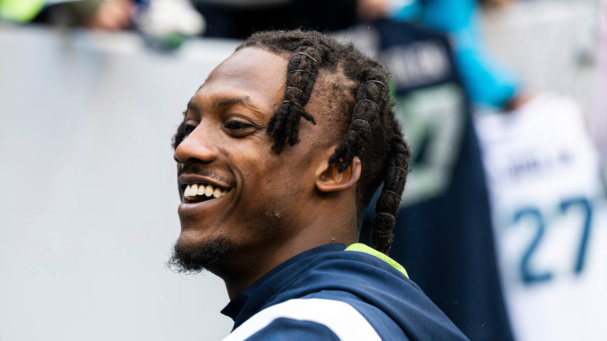 Seattle Seahawks cornerback Tariq Woolen (27) signs fans’ jerseys before the start of an NFL game against the California Panthers at Lumen Field in Seattle Wash., on Dec. 11, 2022.
