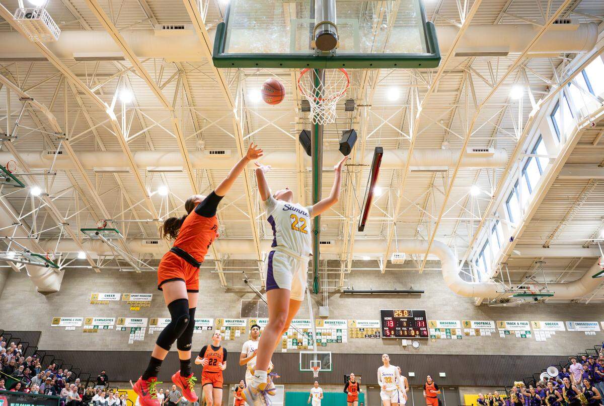 Sumner’s Lainee Houillon (22) goes to the net against Davis’ Averie Brandt (5) during the 4A state regional girls game at Auburn Senior High School, on Saturday, Feb. 24, 2024 in Auburn, Washington.