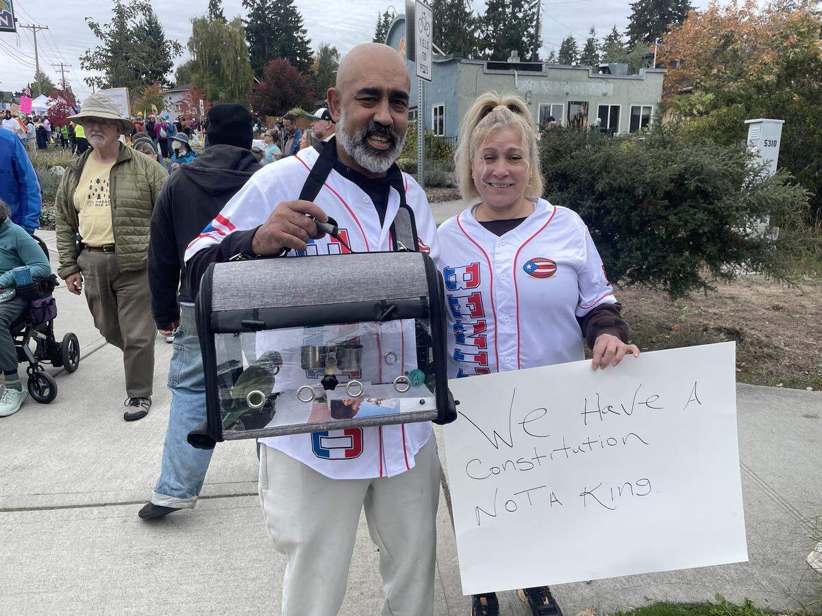 University Place couple David and Marissa Falcon attended the No Kings protest at Point Defiance on Oct. 18, 2025 with their parakeet, Korita. Saturday was Korita’s second political rally, David said.