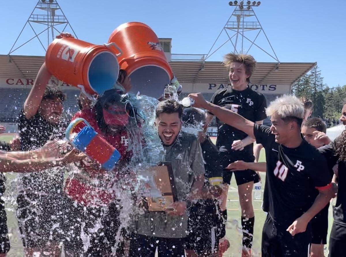 Franklin Pierce’s players douse their coaching staff with a Gatorade bath after winning the 2A district high school boys soccer championship game against Fife, 2-0, on Saturday, May 11, 2024.