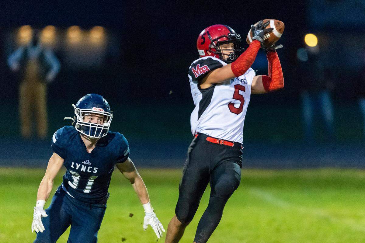 Lynden Christian defensive back Jackson Apol (31) moves in as Mount Baker running back Ayden Rodriguez (5) catches a long pass during the second quarter on Saturday evening March 20, at Lynden Christian High School in Lynden. Lynden Christian defeated Mount Baker 33 to 14.