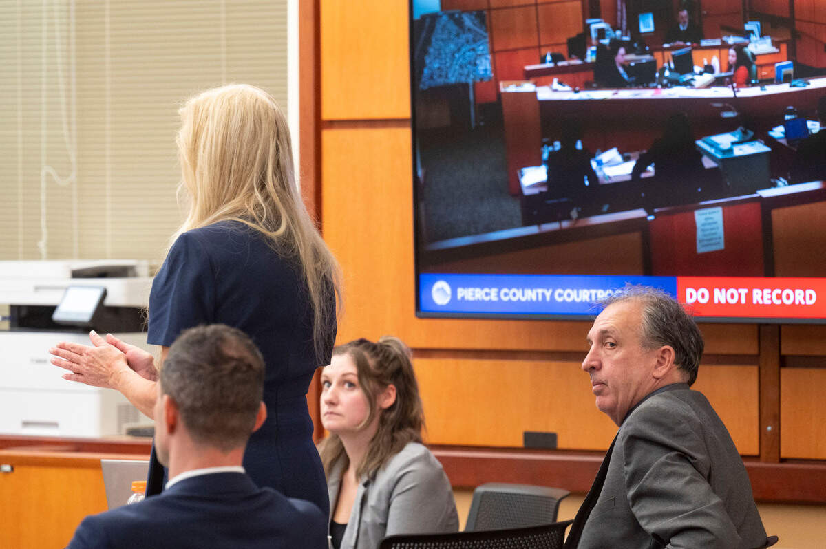 Pierce County Sheriff Ed Troyer looks over his shoulder as his defense attorney, Anne Bremner, argues a motion with the court during the trial on Tuesday, Dec. 6, 2022, in Pierce County District Court in Tacoma, Wash.