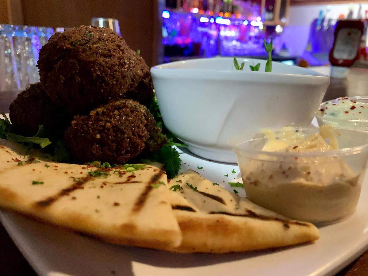 The Alleycat pulls Mediterranean flavors into a menu of pub food, but start with the homemade falafel, served with warm pita, hummus, tzatziki and olives.