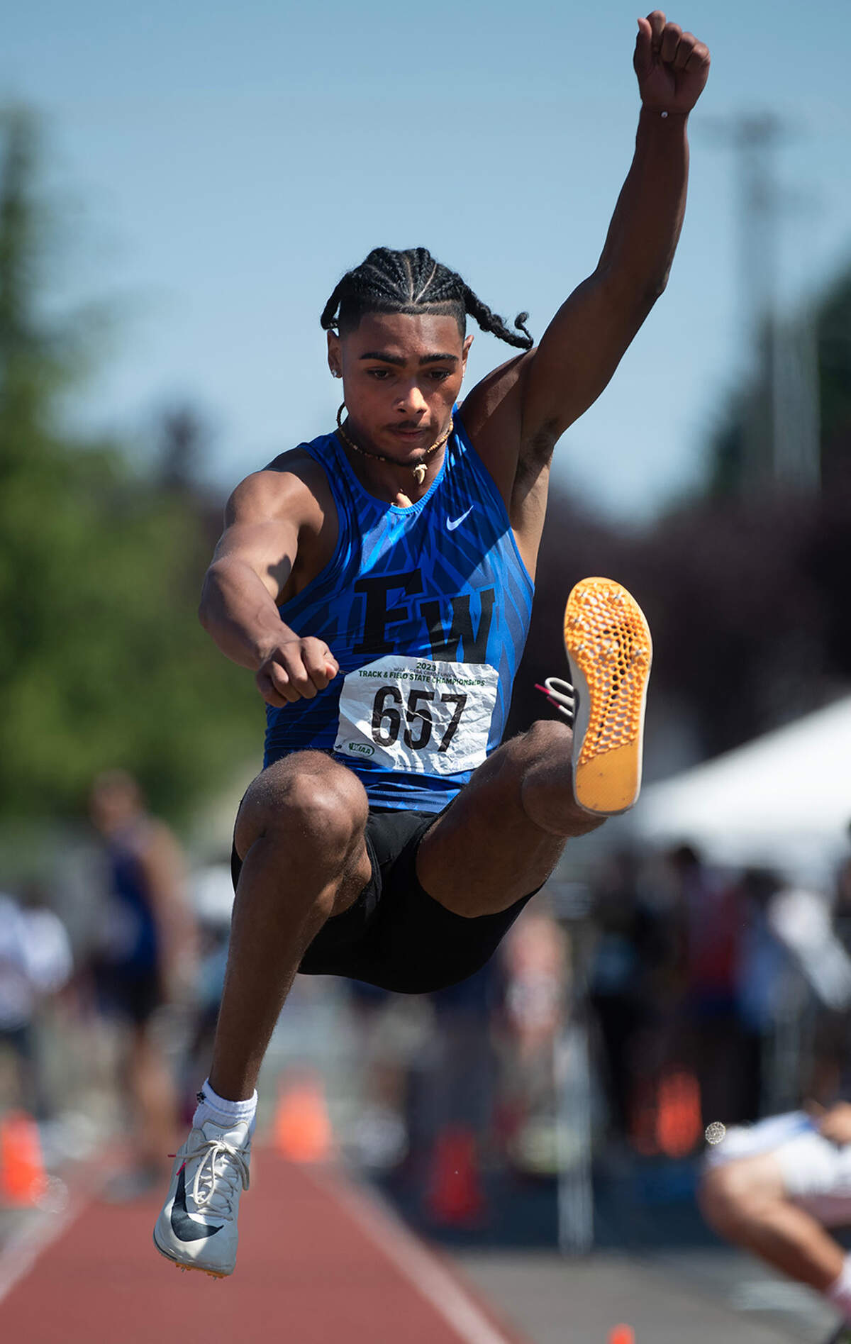 Federal Way’s Julian Gene Fortin jumps to a third-place finish in the 4A boys triple jump competition during the second day of the WIAA state track and field championships at Mount Tahoma High School in Tacoma, Washington, on Friday, May 26, 2023.