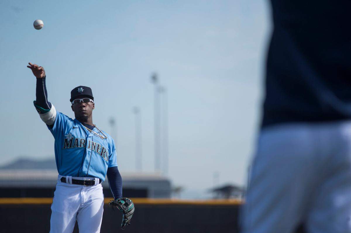 Seattle Mariners second baseman Shed Long plays catch with shortstop J.P. Crawford at spring training on Wednesday, Feb. 19, 2020 in Peoria, Ariz.