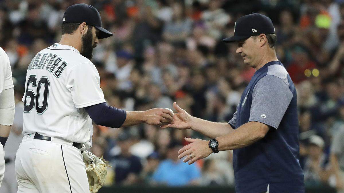 Seattle Mariners pitcher Chasen Bradford hands the ball to manager Scott Servais after being pulled from a baseball against the San Francisco Giants during the sixth inning Tuesday, July 24, 2018, in Seattle. (AP Photo/Ted S. Warren)