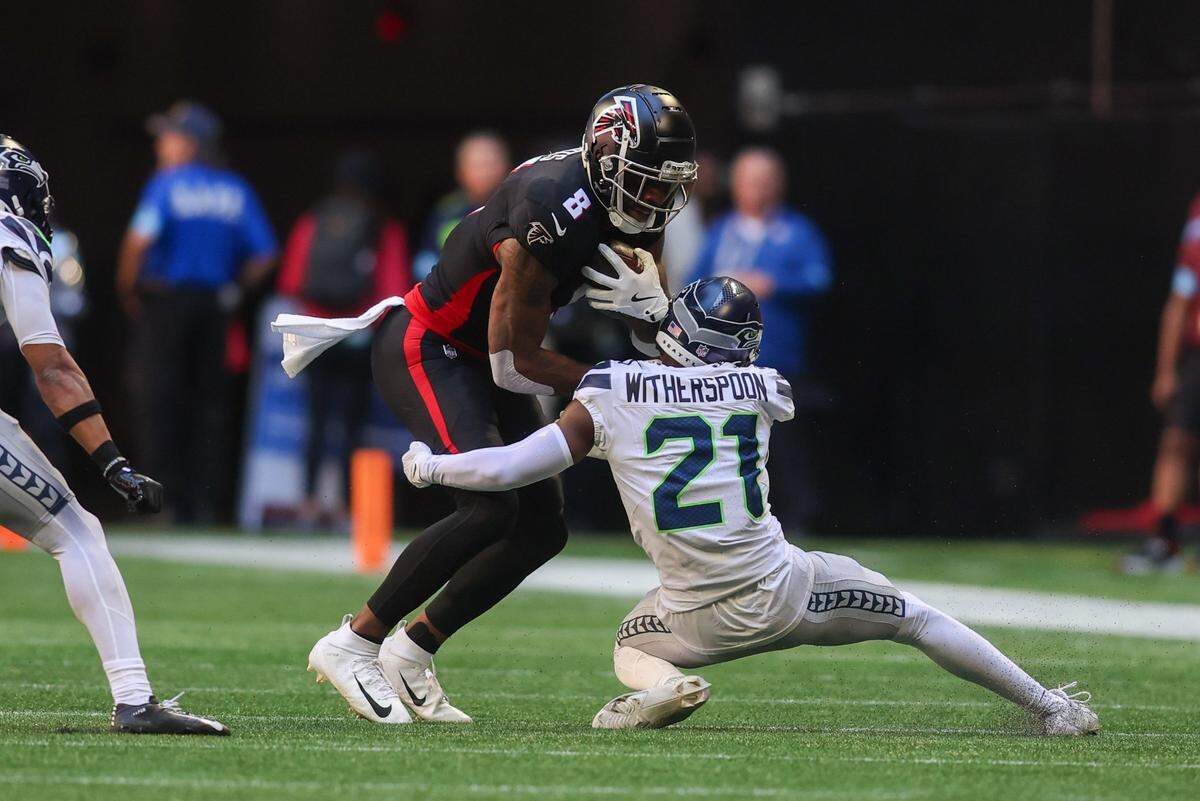 Oct 20, 2024; Atlanta, Georgia, USA; Atlanta Falcons tight end Kyle Pitts (8) is tackled by Seattle Seahawks cornerback Devon Witherspoon (21) in the second quarter at Mercedes-Benz Stadium. Mandatory Credit: Brett Davis-Imagn Images