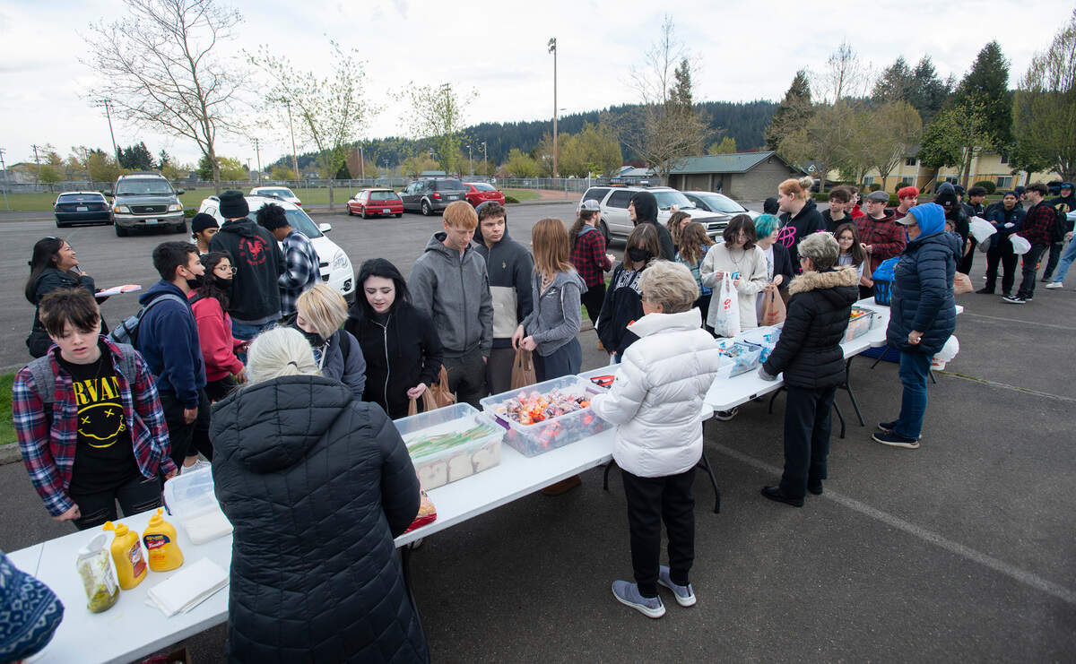 Hundreds of high-school students roll through the free food and snack giveaway from the Mother 2 Many church outreach program at the Sumner Skate Park in Sumner, Washington, on Wednesday, April 13, 2022.