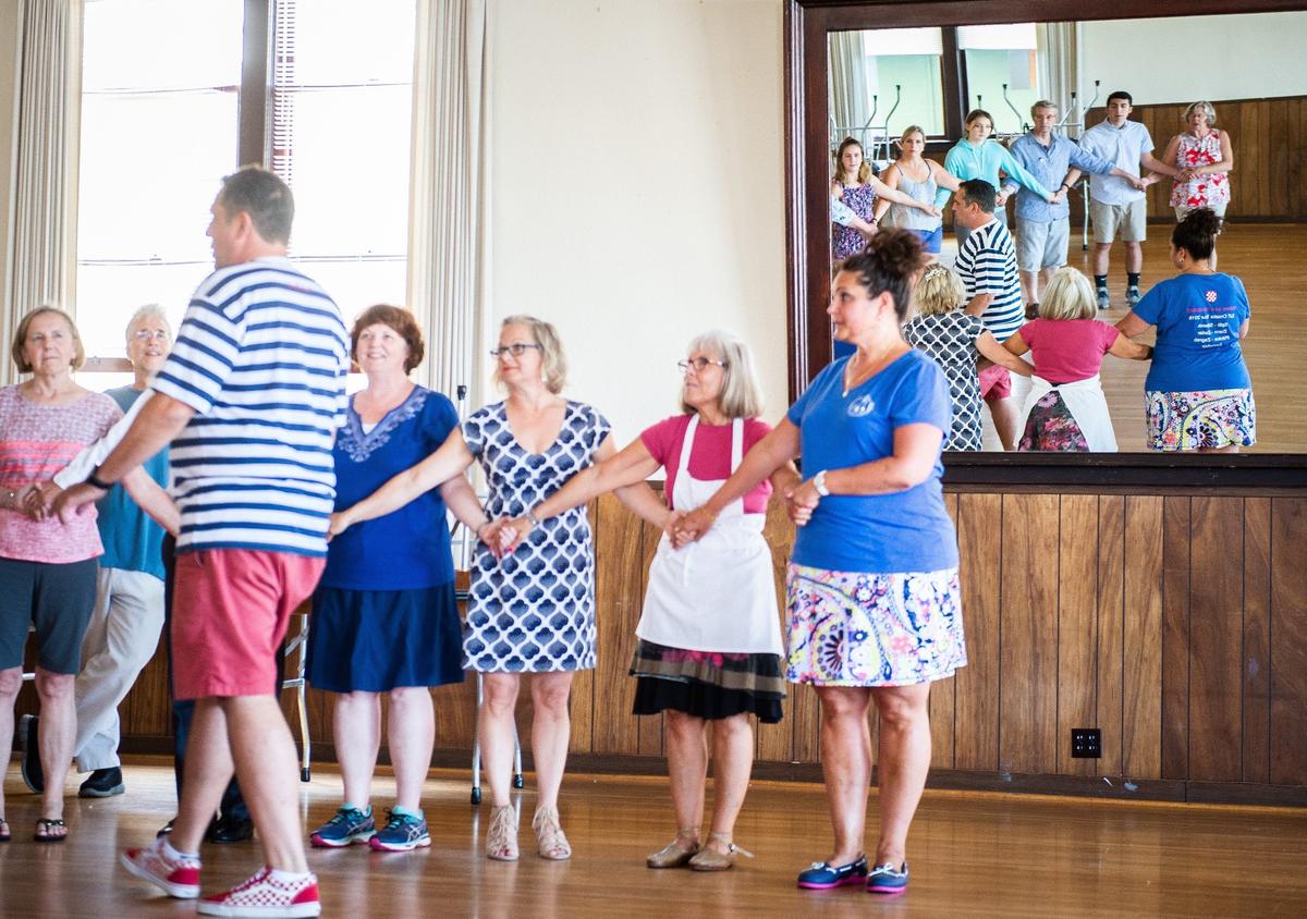 John Morovich, left, and Joanne Abdo, right, teach a kolo lesson at the Slavonian Hall in Tacoma, Wash., on Sunday, Aug. 5, 2018. The Slavonian American Benevolent Society is hosting its second annual Konoba on August 19. The Croatian music festival will feature live music and dancing, traditional drinks, and pastries.