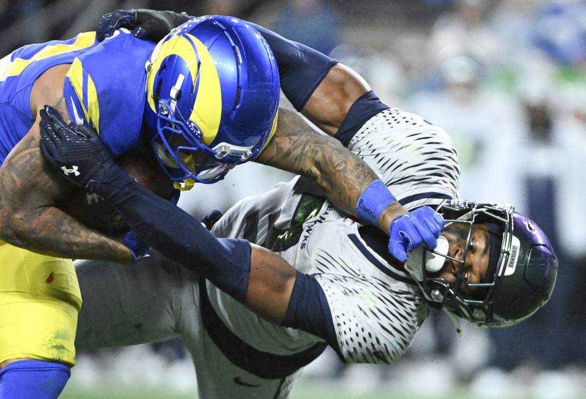 Los Angeles Rams running back Kyren Williams (23) is tackled by Seattle Seahawks safety Nick Emmanwori (3) in the second quarter of the game at Lumen Field, on Thursday, Dec. 18, 2025, in Seattle.