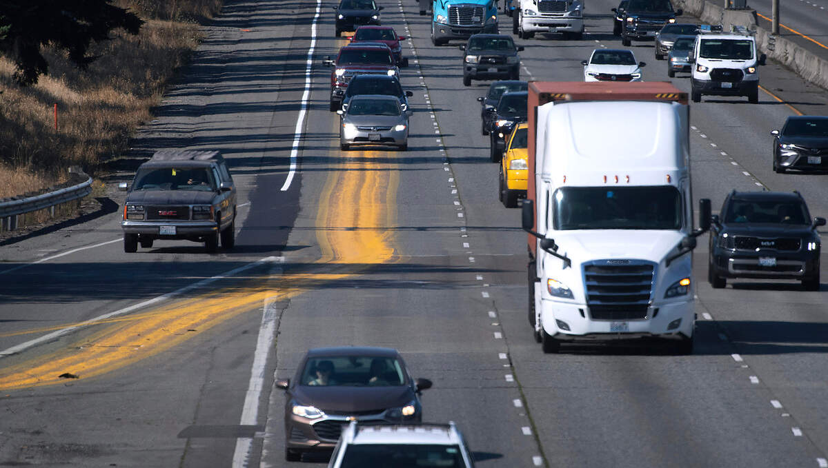 Spilled yellow paint fills the right-hand lane of northbound Interstate 5 through Lakewood, Washington, on Tuesday, Aug. 15, 2023.