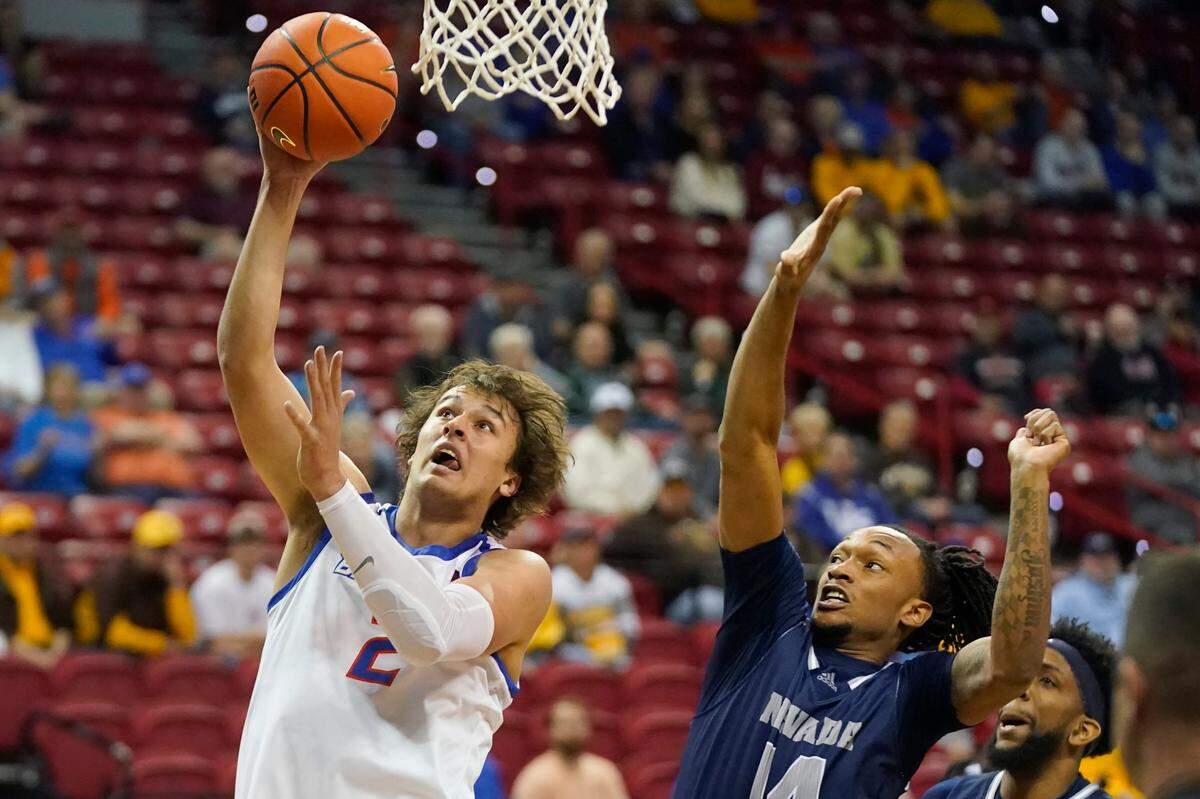 Boise State forward Tyson Degenhart (2) goes to the basket as Nevada forward Tre Coleman (14) defends during the first half of an NCAA college basketball game in the quarterfinals of the Mountain West Conference men’s tournament Thursday, March 10, 2022, in Las Vegas. (AP Photo/Rick Bowmer)