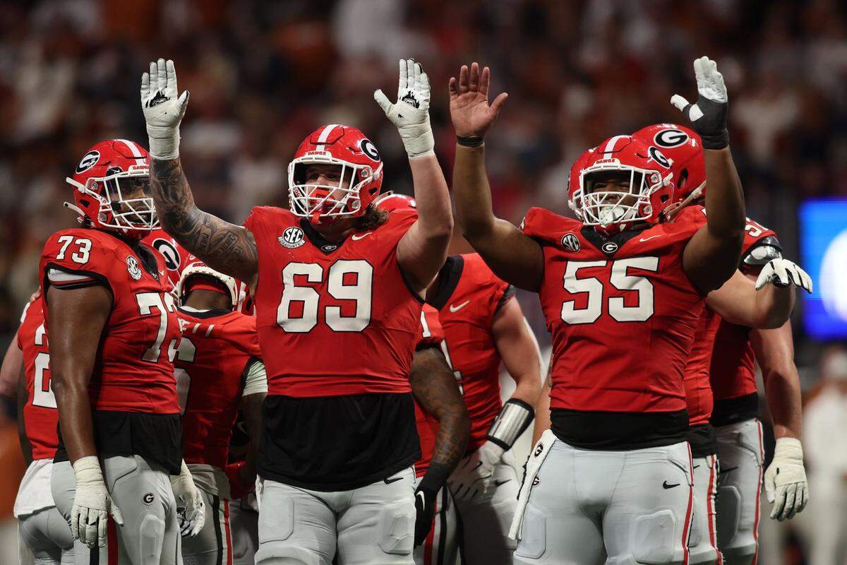 Dec 7, 2024; Atlanta, GA, USA; Georgia Bulldogs offensive lineman Tate Ratledge (69) and offensive lineman Jared Wilson (55) react during the second half in the 2024 SEC Championship game at Mercedes-Benz Stadium. Mandatory Credit: Brett Davis-Imagn Images