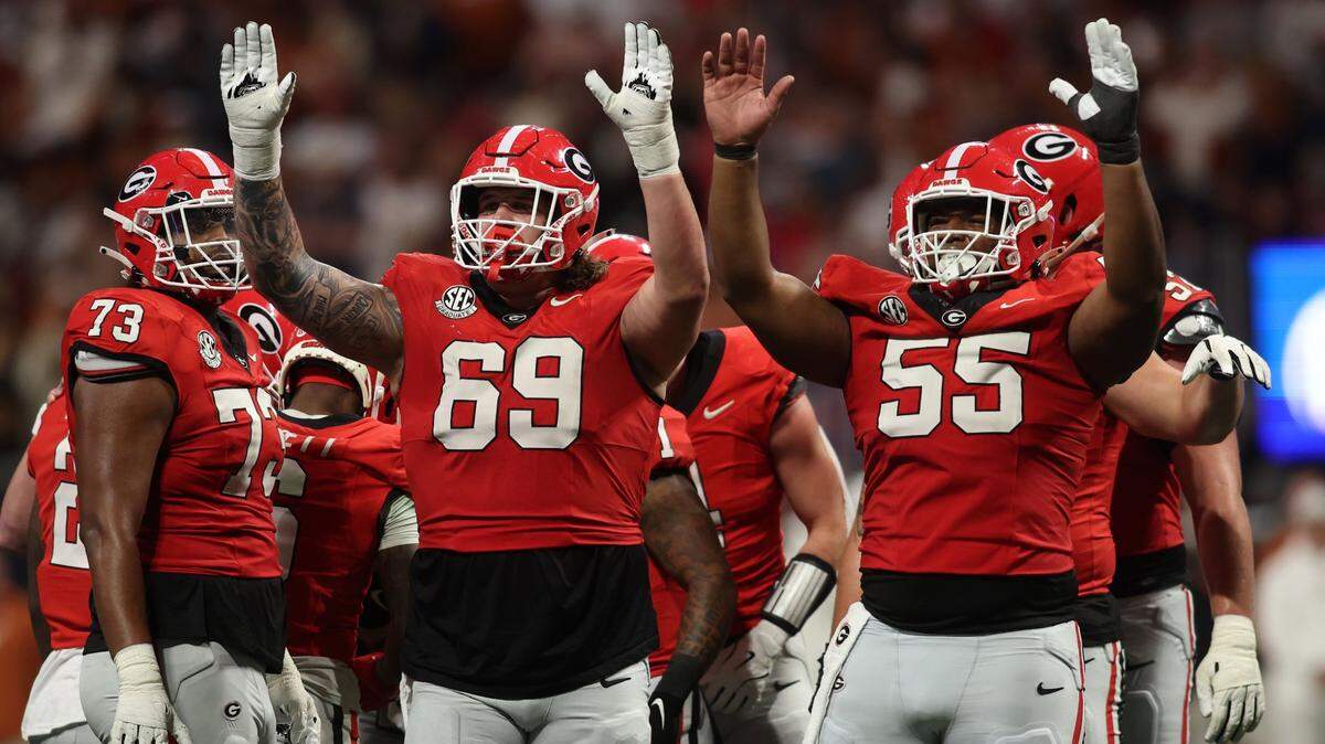 Dec 7, 2024; Atlanta, GA, USA; Georgia Bulldogs offensive lineman Tate Ratledge (69) and offensive lineman Jared Wilson (55) react during the second half in the 2024 SEC Championship game at Mercedes-Benz Stadium. Mandatory Credit: Brett Davis-Imagn Images