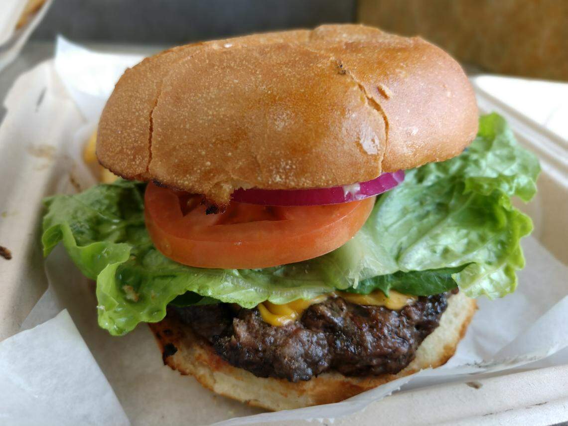 A cheeseburger with lettuce, tomato and onion from Build-A-Burger in Tacoma.
