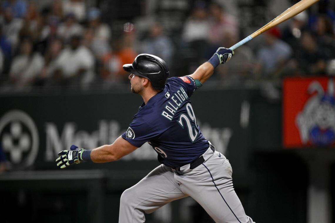 May 2, 2025; Arlington, Texas, USA; Seattle Mariners catcher Cal Raleigh (29) hits a grand slam against the Texas Rangers during the fifth inning at Globe Life Field. Mandatory Credit: Jerome Miron-Imagn Images