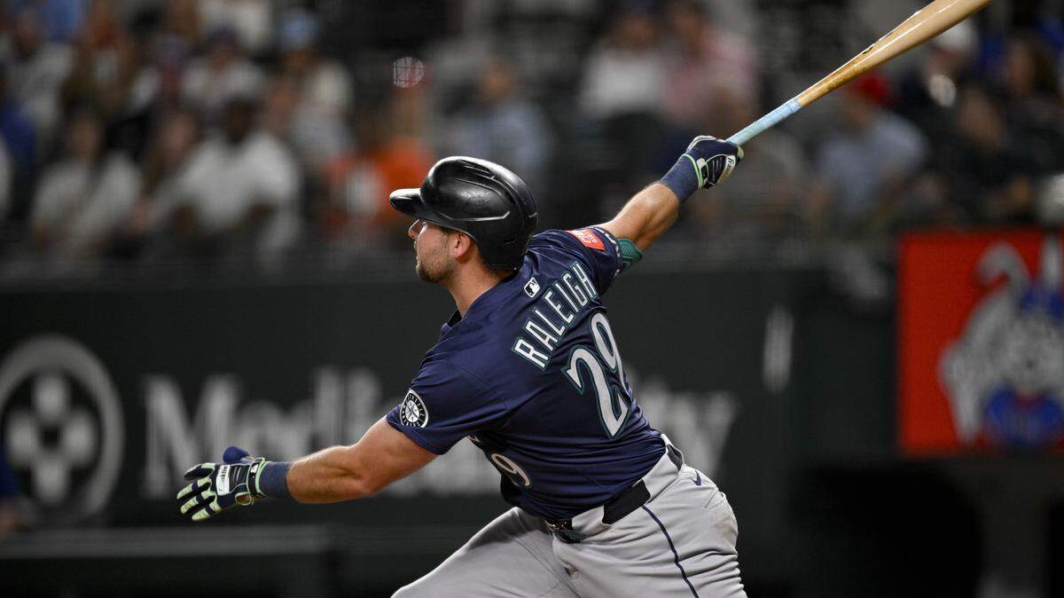 May 2, 2025; Arlington, Texas, USA; Seattle Mariners catcher Cal Raleigh (29) hits a grand slam against the Texas Rangers during the fifth inning at Globe Life Field. Mandatory Credit: Jerome Miron-Imagn Images