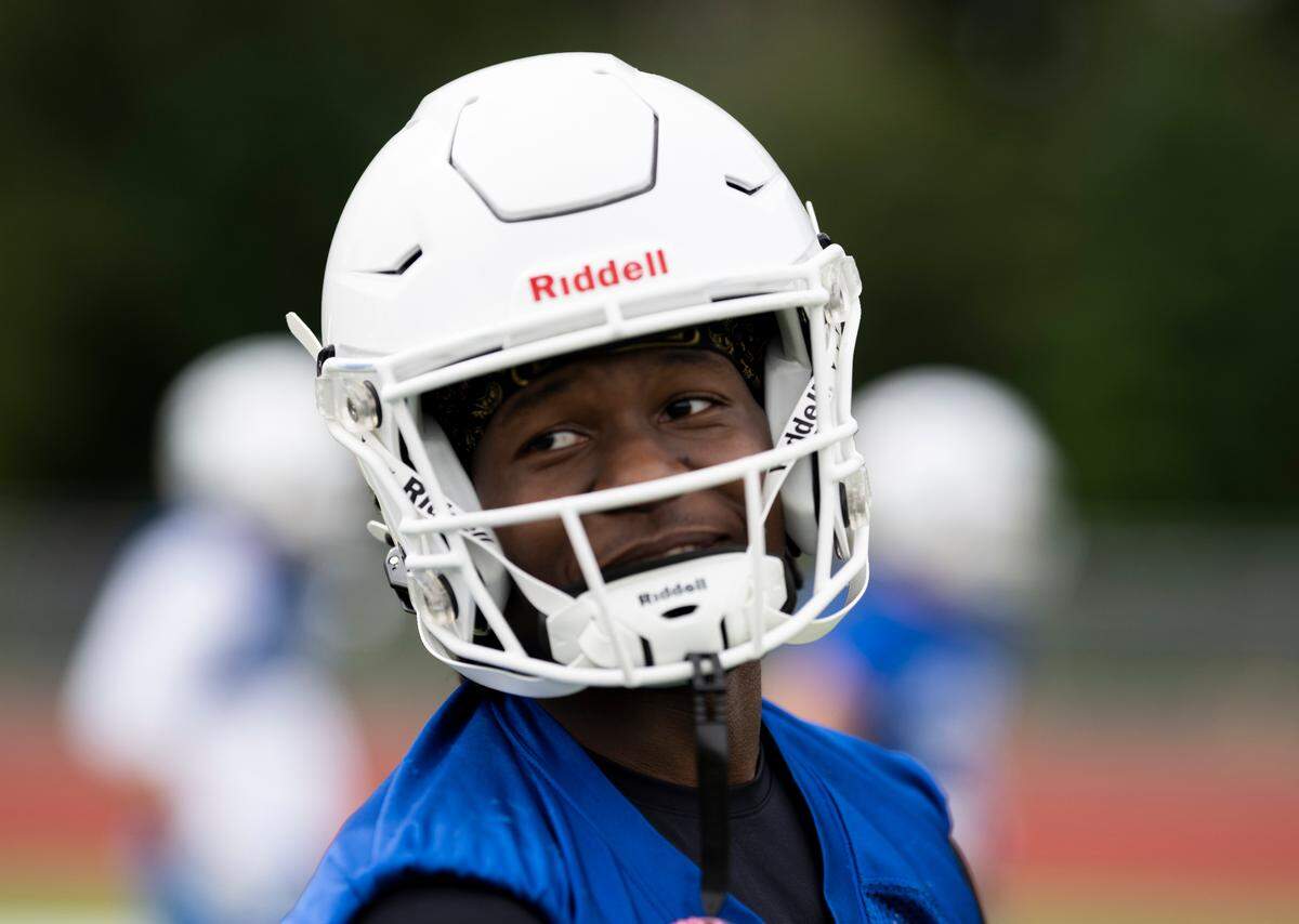 Graham-Kapowsin wide receiver Khris Norris laughs before catching a pass in a drill during a football practice at Graham-Kapowsin High School, on Thursday, Aug. 22, 2024, in Graham, Wash.