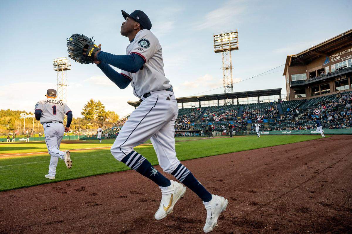 Tacoma Rainiers outfielder Marcus Wilson (14) jogs out onto the field at the beginning of the top of the first inning during the season opener against against the Salt Lake Bees at Cheney Stadium in Tacoma, Wash., Tuesday on April 5, 2022.