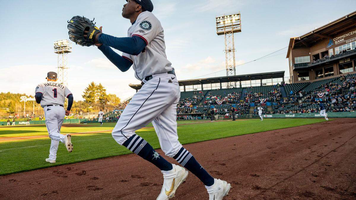Tacoma Rainiers outfielder Marcus Wilson (14) jogs out onto the field at the beginning of the top of the first inning during the season opener against against the Salt Lake Bees at Cheney Stadium in Tacoma, Wash., Tuesday on April 5, 2022.