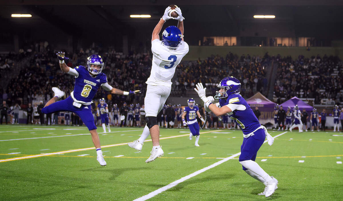 Curtis wide receiver Parker Mady pulls in a leaping catch b between Puyallup defenders Seanje’ Finister (8) and Jayden Woodland during Friday night’s football game at Sparks Stadium in Puyallup, Washington, Oct. 25, 2024. Puyallup won the game, 49-35.