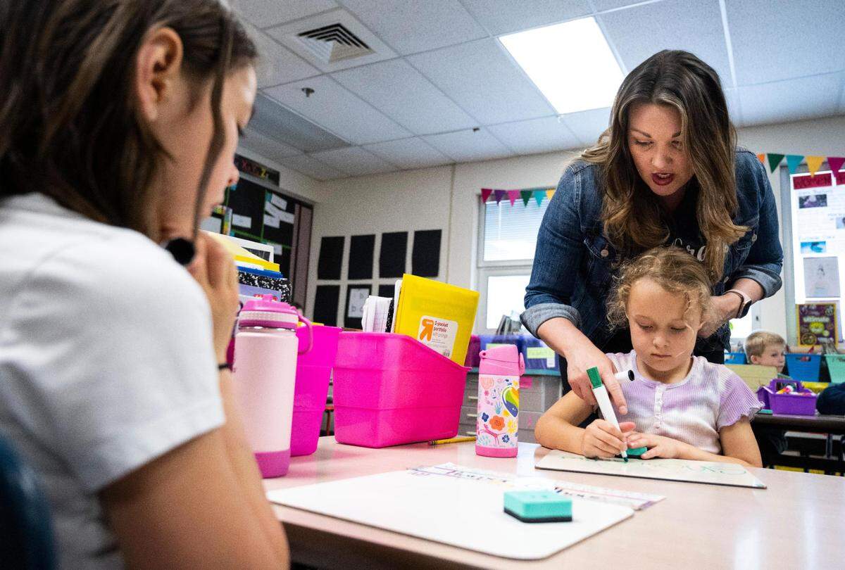 Tracy Morrison helps her first grade student Addie Airey spell a word correctly during her Enhanced Core Reading Instruction training (ECRI) class at Harbor Heights Elementary in Wollochet, Wash. on Friday, June 3, 2022.