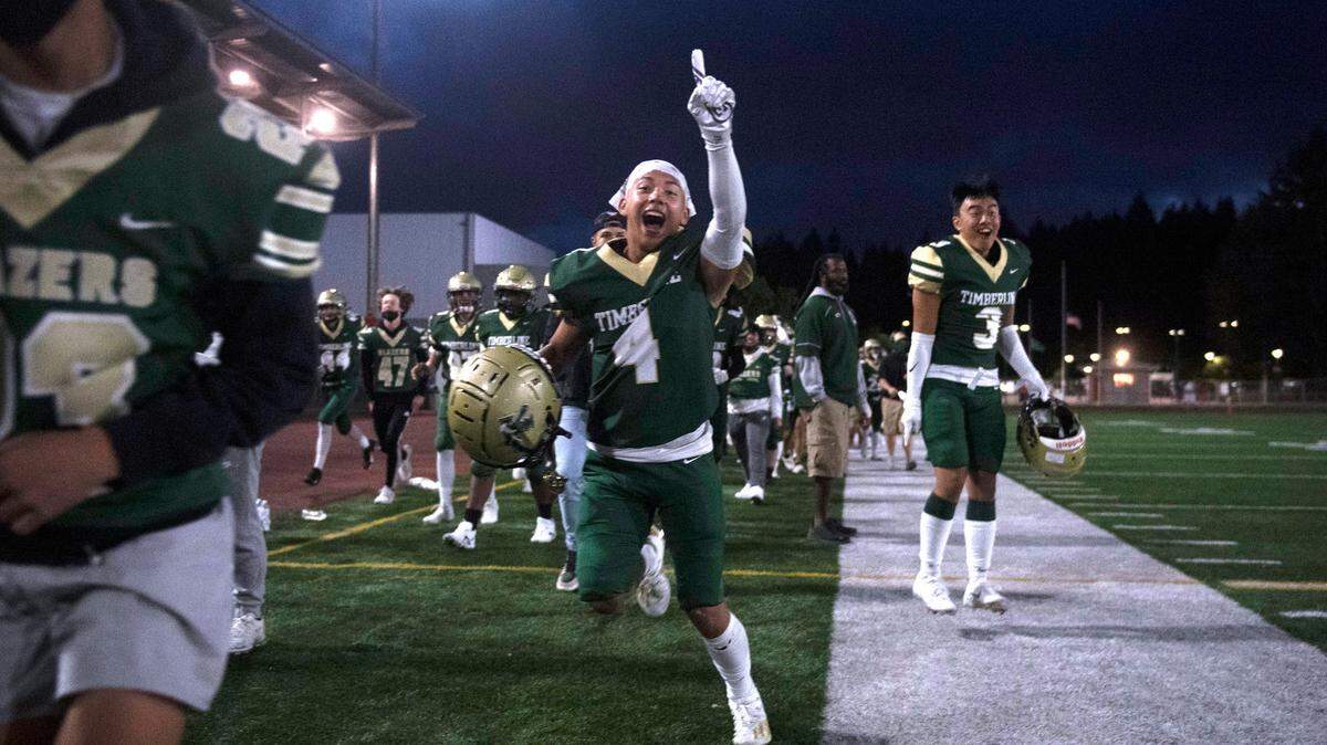 Timberline wide receiver Landon Rith celebrates on the sidelines as Darell Gipson breaks loose for a 72-yard touchdown reception during Friday night’s non-league football game against the Kent Meridian Royals at South Sound Stadium in Lacey, Washington, Sept. 10, 2021.