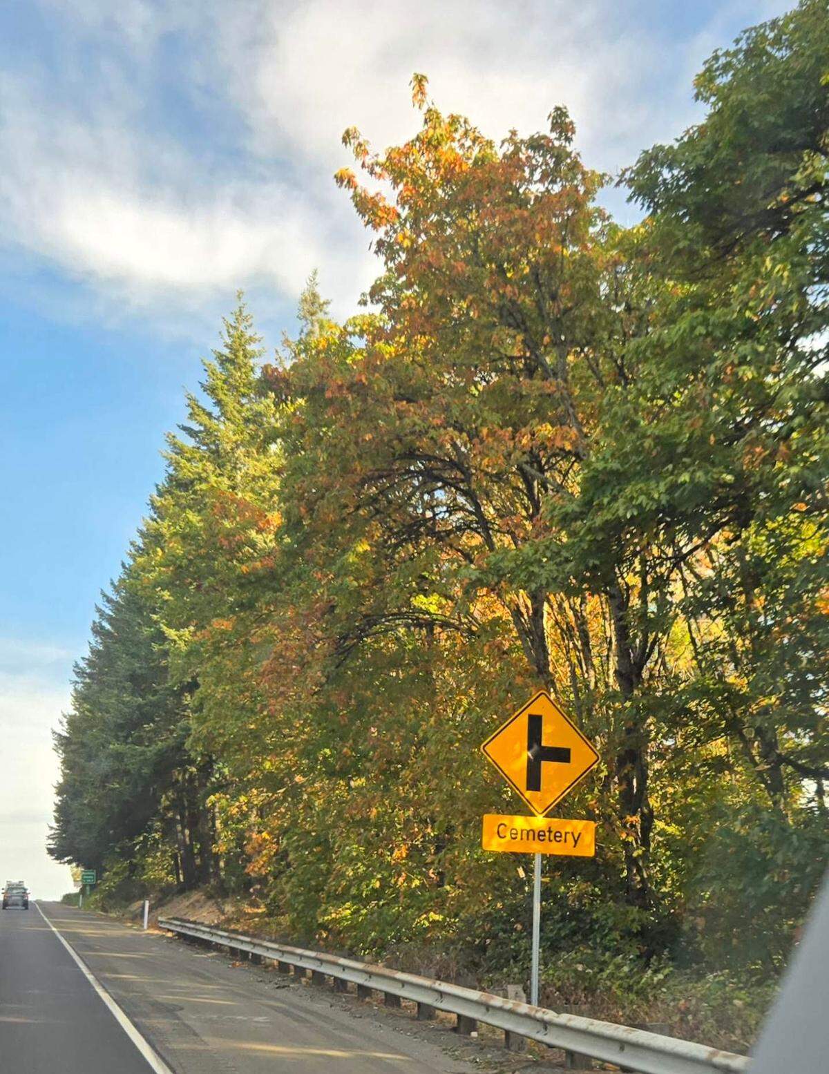 Signs on both sides of state Route 16 alert drivers to the upcoming Haven of Rest cemetery, where drivers must turn sharply off the highway to access the cemetery in Gig Harbor, Wash.