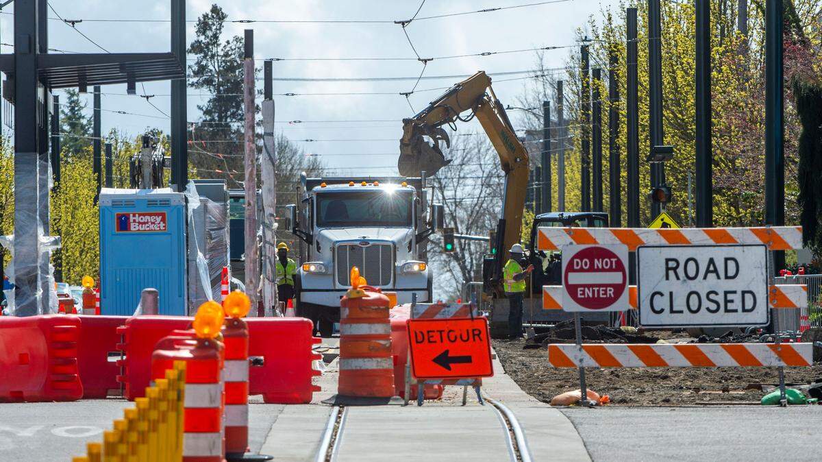 A construction crew works on paving the road alongside the Sound Transit Hilltop Tacoma Link track on Martin Luther King Jr. Way next to the Tacoma General stop near Tacoma General Hospital on Tuesday, April 5, 2022, in Tacoma, Wash.